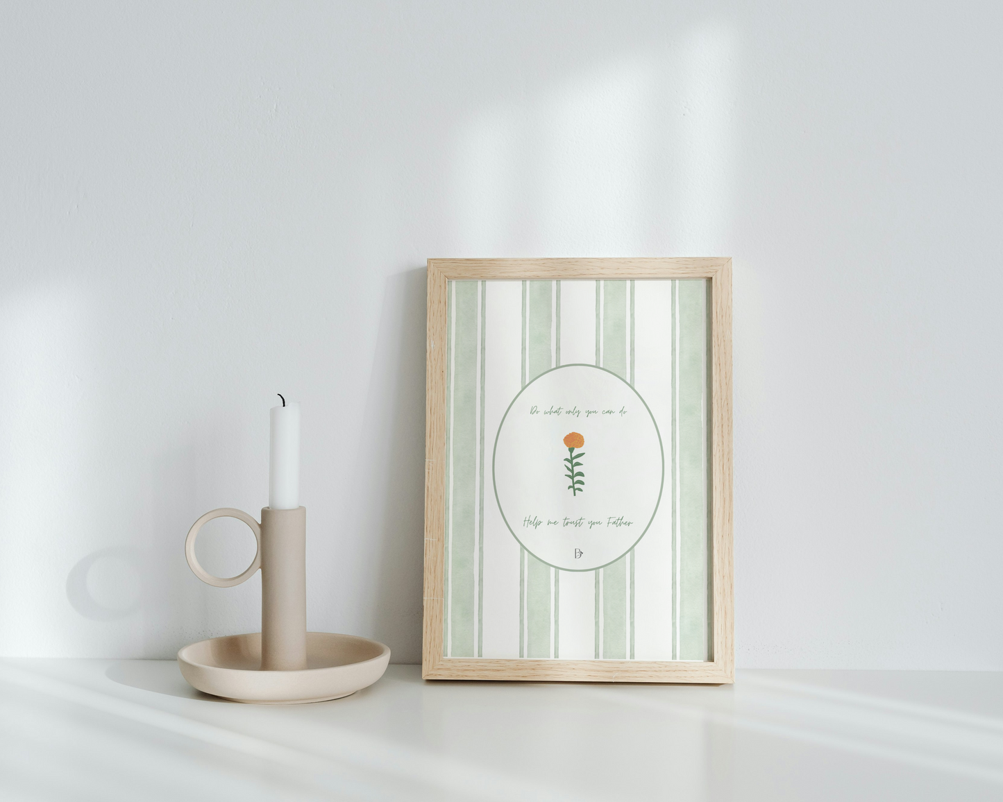 Framed artwork with a candle on a white surface