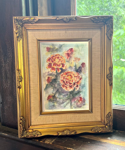 Framed marigold painting on a vintage window sill 